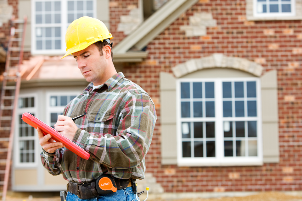 man with hard hat and clipboard